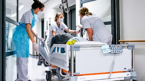 Pflegepersonal schiebt ein Bett in der Kohortenabteilung des Catharina-Krankenhauses in den Niederlanden. (Archivbild: 30.12.2020) (picture alliance/dpa/ANP)