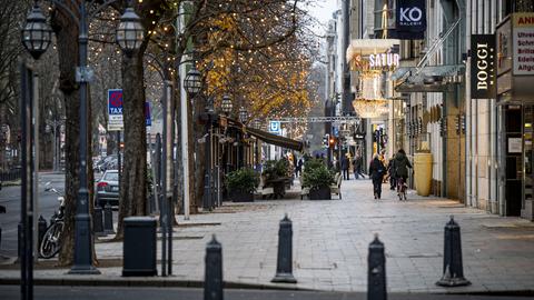 Nur wenige Menschen sind vor Ladenöffnung in der Düsseldorfer Königsallee unterwegs. (dpa)