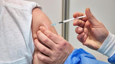 Ein Mann wird in einem Impfzentrum in Schleswig-Holstein gegen das Coronavirus geimpft (dpa)