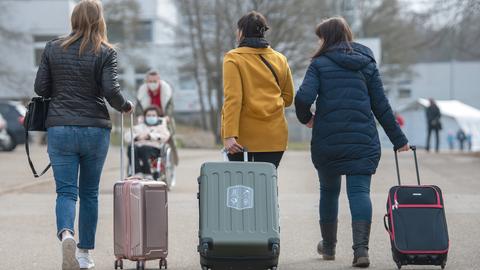 Drei aus der Ukraine stammende Frauen gehen in der Landeserstaufnahmestelle für Flüchtlinge (LEA) zu ihrem Quartier.  (dpa)