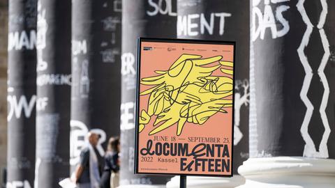 Ein Plakat der documenta in einem Plakatständer vor den Säulen des Museums Fridericianum. (picture alliance/dpa)